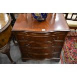 A Georgian style mahogany serpentine front chest fitted with a slide over  three long drawers,