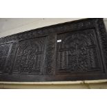 An antique floral and foliate carved oak panel/headboard