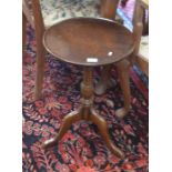 A pair of circular mahogany tripod occasional tables