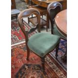A set of six carved mahogany balloon back dining chairs with green dralon upholstery, turned front