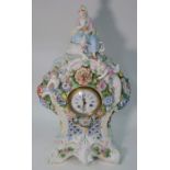 A 20th century continental porcelain mantel clock decorated in bold relief