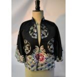 A vintage Chinese black silk embroidered jacket, a silk sari and an Armand Marseille doll
