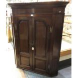 A Georgian mahogany hanging corner cabinet