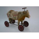A child's antique straw-stuffed ride-on cow