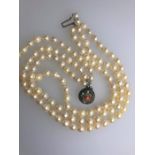 A triple row uniform cultured pearl choker