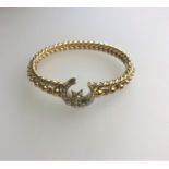 A Victorian yellow gold half-hinged rope twist bangle with pearl set moon and star
