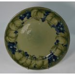 A William Moorcroft celadon ground plate decorated with the 'Leaf and Berry' design