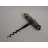 A Victorian corkscrew with embossed silver handle