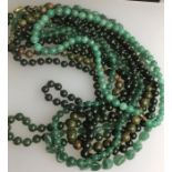 Seven various green glass/hard stone bead necklaces