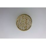 An 18ct yellow gold stylised roundel brooch