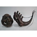 A 19th century Japanese carved hardwood Noh mask and a brush mounted hardwood powder horn