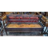 An antique continental fruitwood box settle / bench, the part spindle back over a hinged storage wel