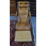 A Victorian style steel framed brown buttoned leather upholstered rocking chair, after a design by R
