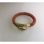 A Victorian coral and yellow gold serpent bangle