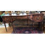 A Regency figured mahogany break-bowfront sideboard in the Gillows manner