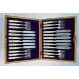 A walnut cased late Victorian set of twelve silver fish knives and forks