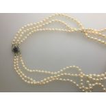 A three-row graduated cultured pearl necklace