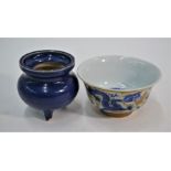 A 20th century Chinese porcelain bowl and a small Ming style powder blue glaze tripod censer