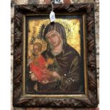 An antique Coptic icon, Madonna and Child, painted and gilded on panel