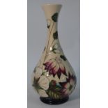 A modern Moorcroft bottle vase decorated with wild strawberries