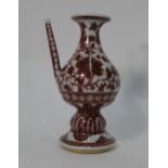 A Chinese porcelain holy water vessel or ewer painted in underglaze copper red
