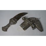 An antique Arab dagger Jambiya, the low-grade silver hilt and scabbard richly decorated with wire fi