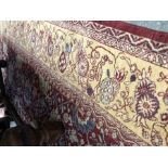 A contemporary Persian Ziegler design carpet, floral design in rust ground with conforming cream bor