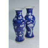 A pair of Chinese blue and white prunus vases on cracked ice ground