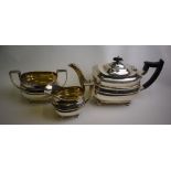 A silver three-piece tea service