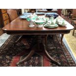 A Georgian mahogany twin pedestal dining table on turned pillars