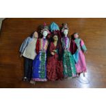 Four Chinese costume dolls and a Spanish costume doll