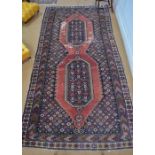 An antique Caucasian kelleh carpet, the large twin lozenge design on blue/red ground