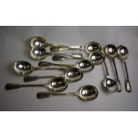 A matched set of twelve silver fiddle and thread soup spoons
