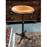 A Victorian cast iron mahogany top adjustable kettle table