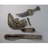 An Arab dagger Jambiya, the low-grade silver hilt, scabbard and belt richly decorated with wire fili