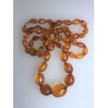 A row of graduated facetted amber beads