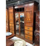 A late Victorian inlaid mahogany inverted breakfront wardrobe