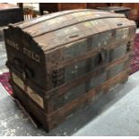 An antique dome top trunk, the interior branded for 'Garrards'