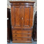 A Victorian flame mahogany linen press on chest, with pair of moulded panel doors enclosing six slid