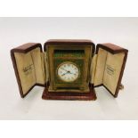 A vintage green enamelled gilt cased miniature travelling alarm clock