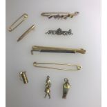 A collection of various pin brooches