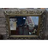 An antique giltwood framed wall mirror, 63 cm x 72 cm