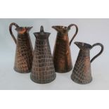 Four Arts & Crafts copper tapering jugs