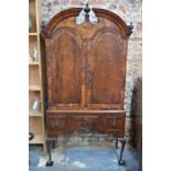 A William & Mary 18th feather-banded walnut dome top library cabinet on (later) stand