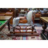 An antique painted wood grey rocking horse
