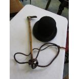 Vintage riding/hunting crop/whip and a bowler hat.