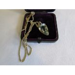 Gold-mounted green stone and diamond pendant