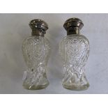 Two silver-lidded crystal scent bottles