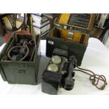 Two green boxed military issue field telephones