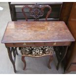 An Edwardian walnut nursing chair together with a small desk with pierced sides